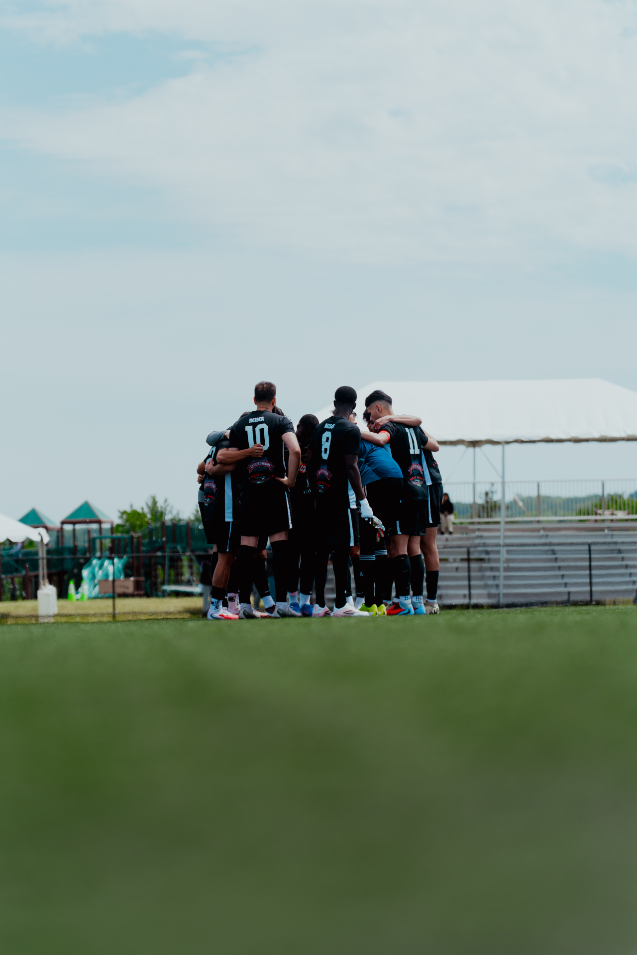 Brishna FC team huddle before kickoff