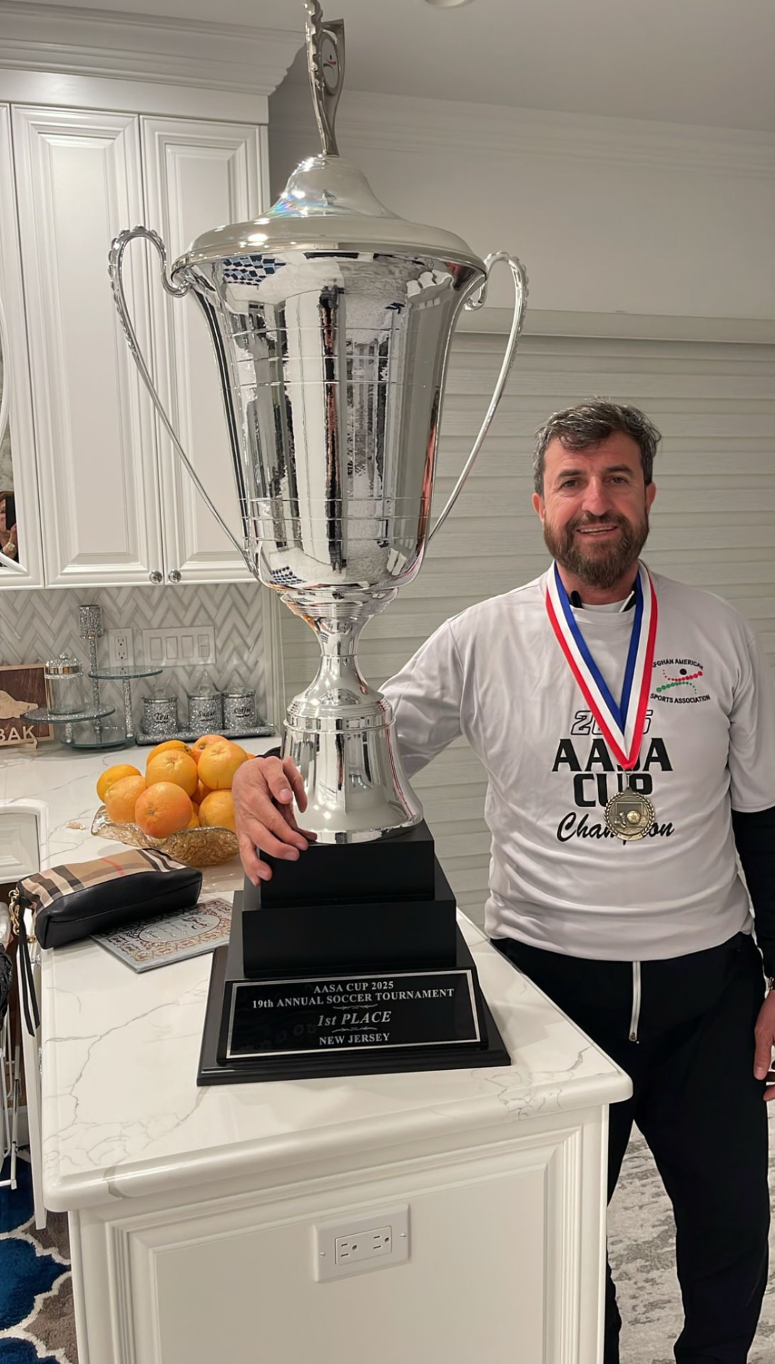 Coach Ibrahim Mashriqi with the 2025 AASA Cup trophy
